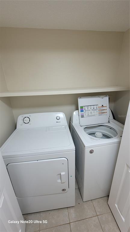 12025 Proctor Loop, Unit 1 New Port Richey, FL 34654 - Photo 10 of 11 a utility room with dryer and washer