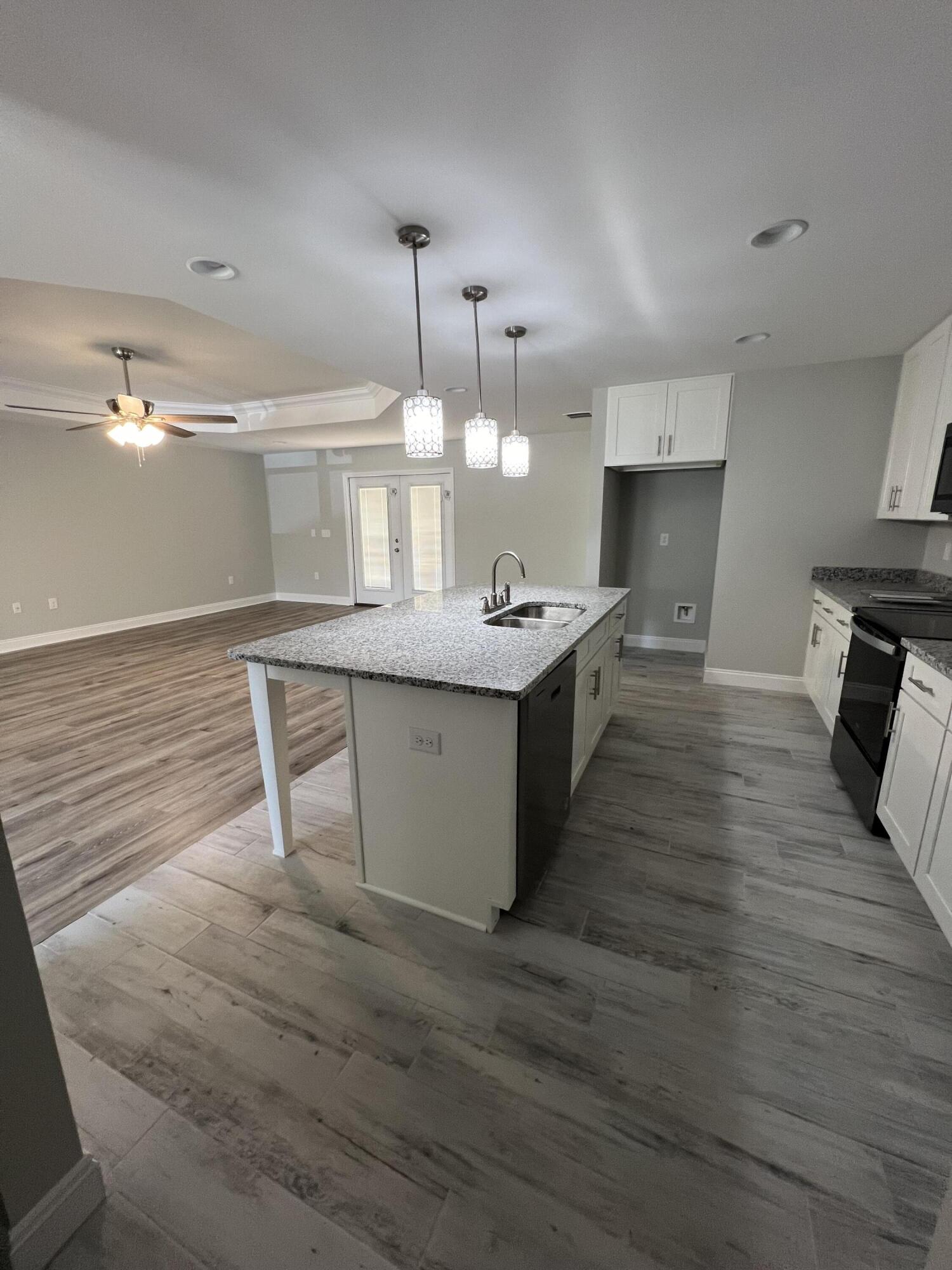 3931 Poverty Creek Road Crestview, FL 32539 - Photo 14 of 34 a large kitchen with kitchen island a sink stainless steel appliances and cabinets