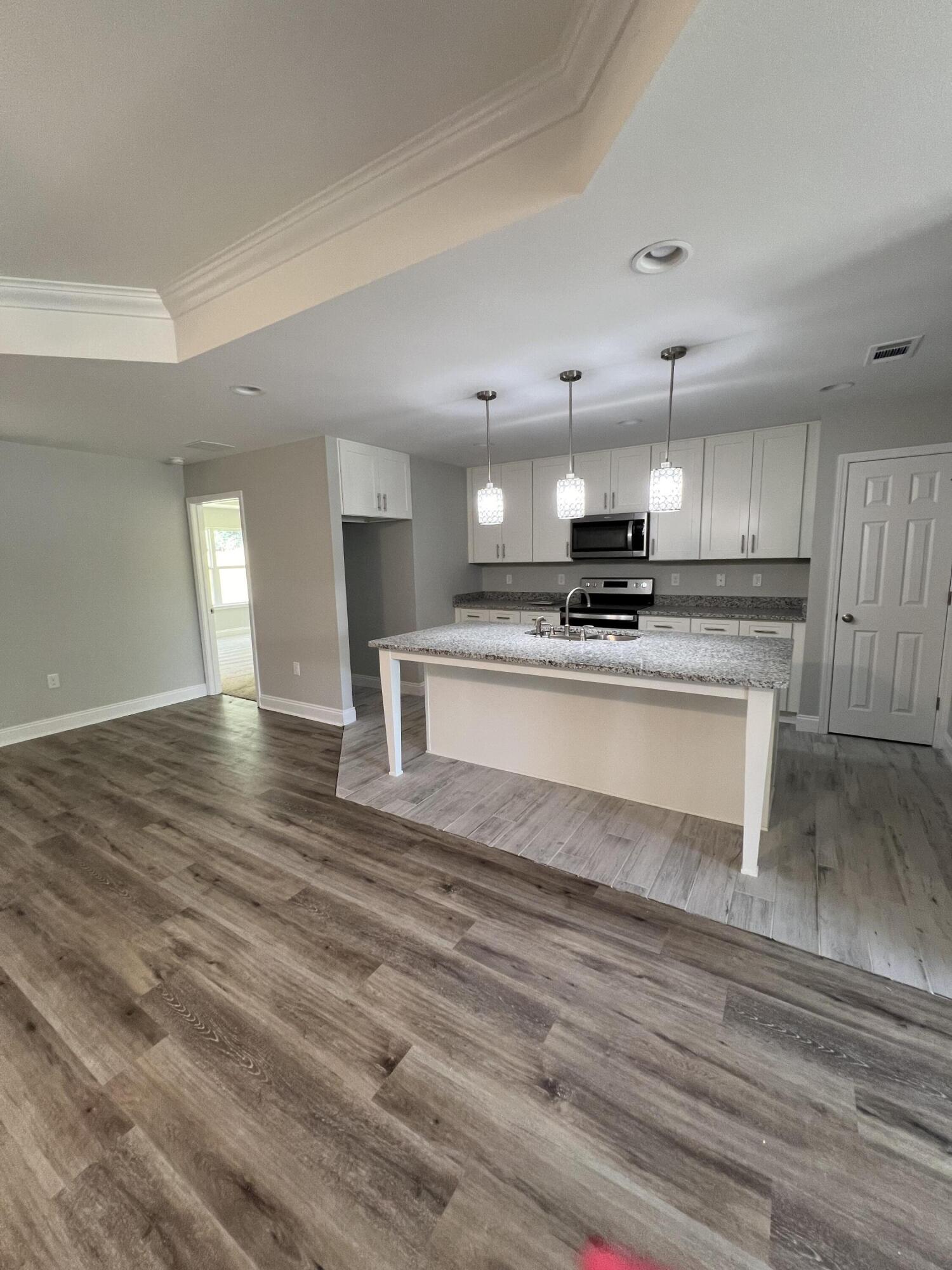 3931 Poverty Creek Road Crestview, FL 32539 - Photo 15 of 34 a large kitchen with stainless steel appliances granite countertop a stove and a sink