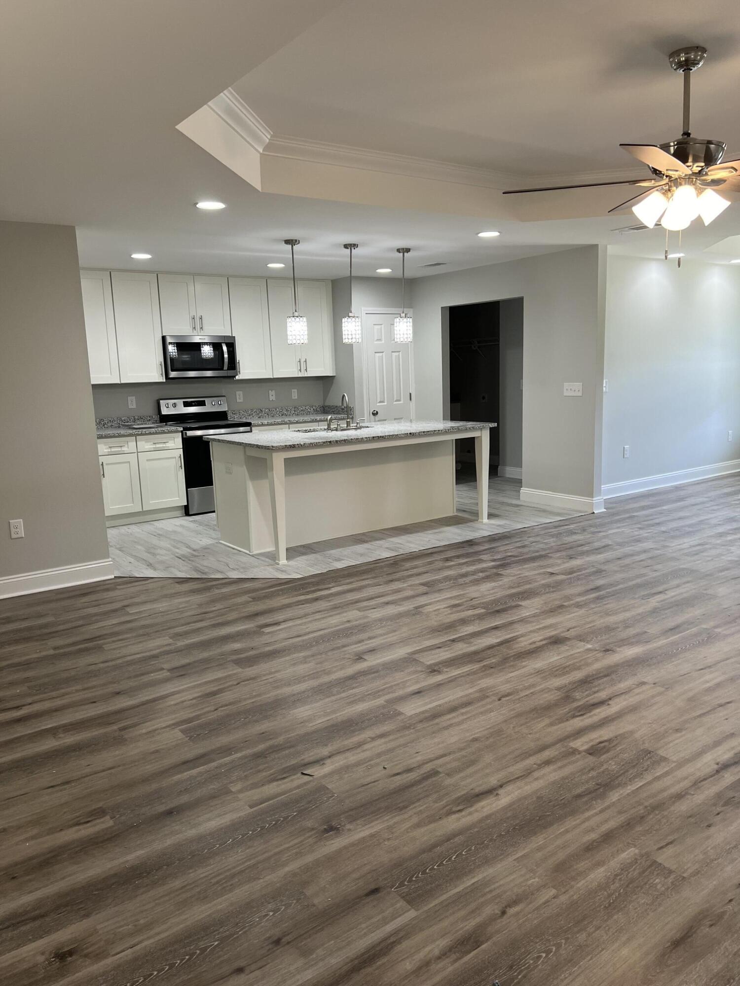 3931 Poverty Creek Road Crestview, FL 32539 - Photo 16 of 34 a large kitchen with stainless steel appliances granite countertop a large counter top a stove and a refrigerator