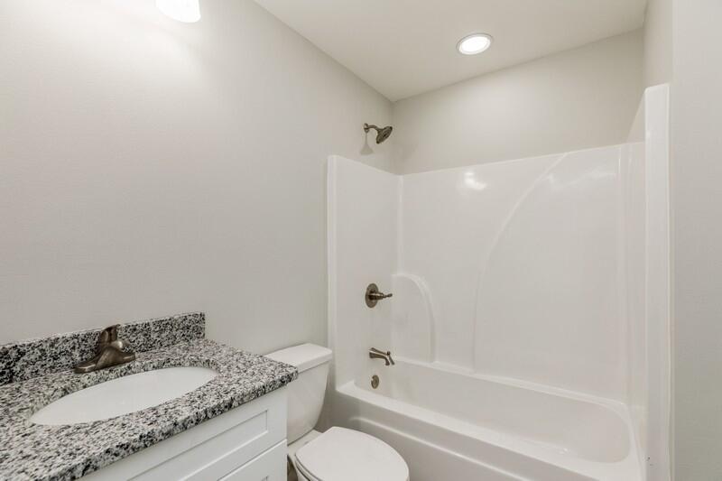 3931 Poverty Creek Road Crestview, FL 32539 - Photo 20 of 34 a bathroom with a granite countertop sink a toilet and bathtub