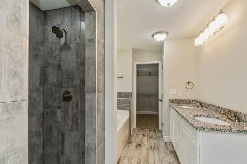 3931 Poverty Creek Road Crestview, FL 32539 - Photo 26 of 34 a bathroom with a granite countertop sink a shower and a mirror