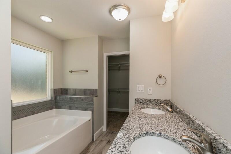 3931 Poverty Creek Road Crestview, FL 32539 - Photo 29 of 34 a bathroom with a granite countertop bathtub sink and toilet