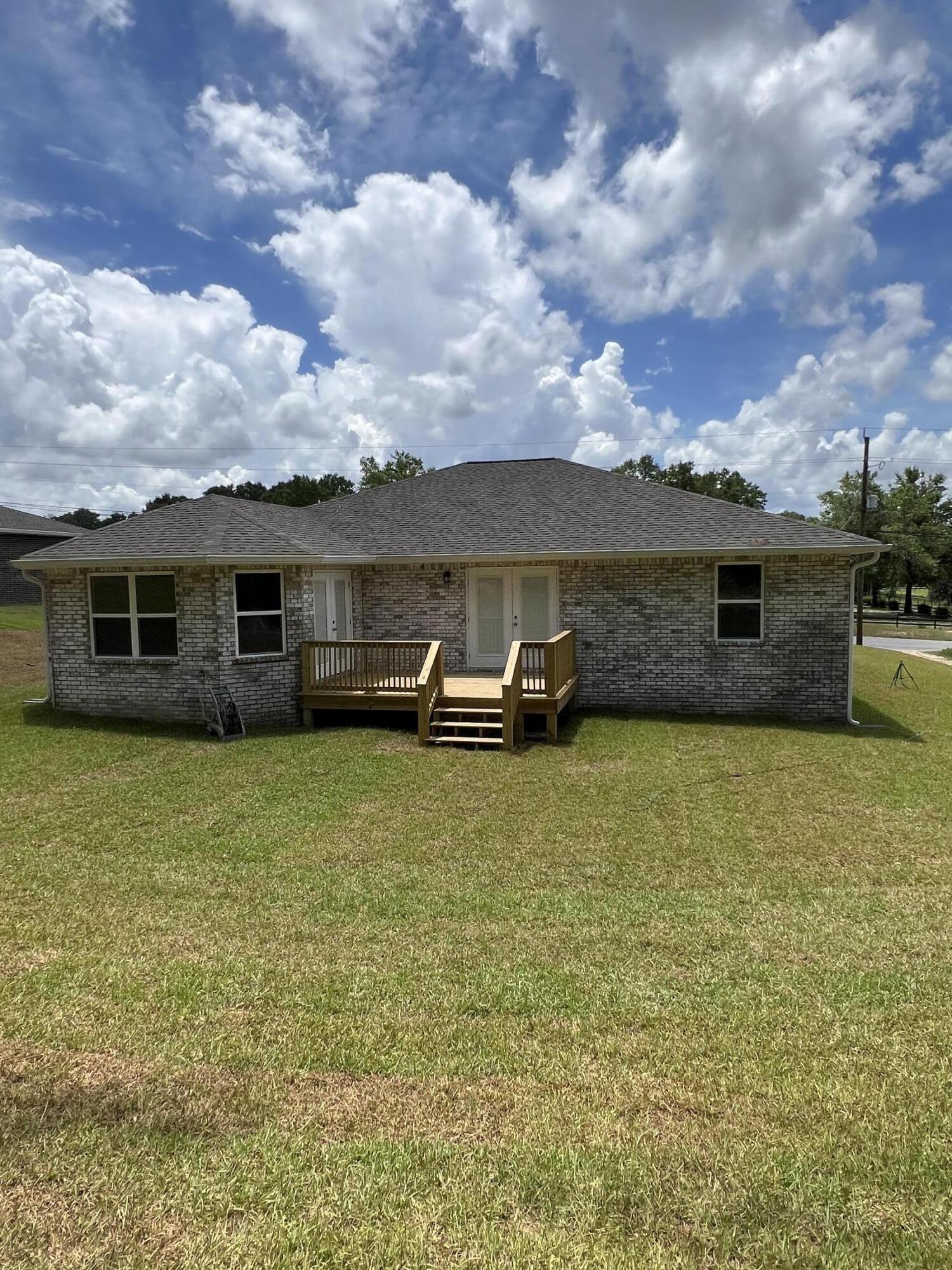 3931 Poverty Creek Road Crestview, FL 32539 - Photo 3 of 34 a front view of a house with a garden