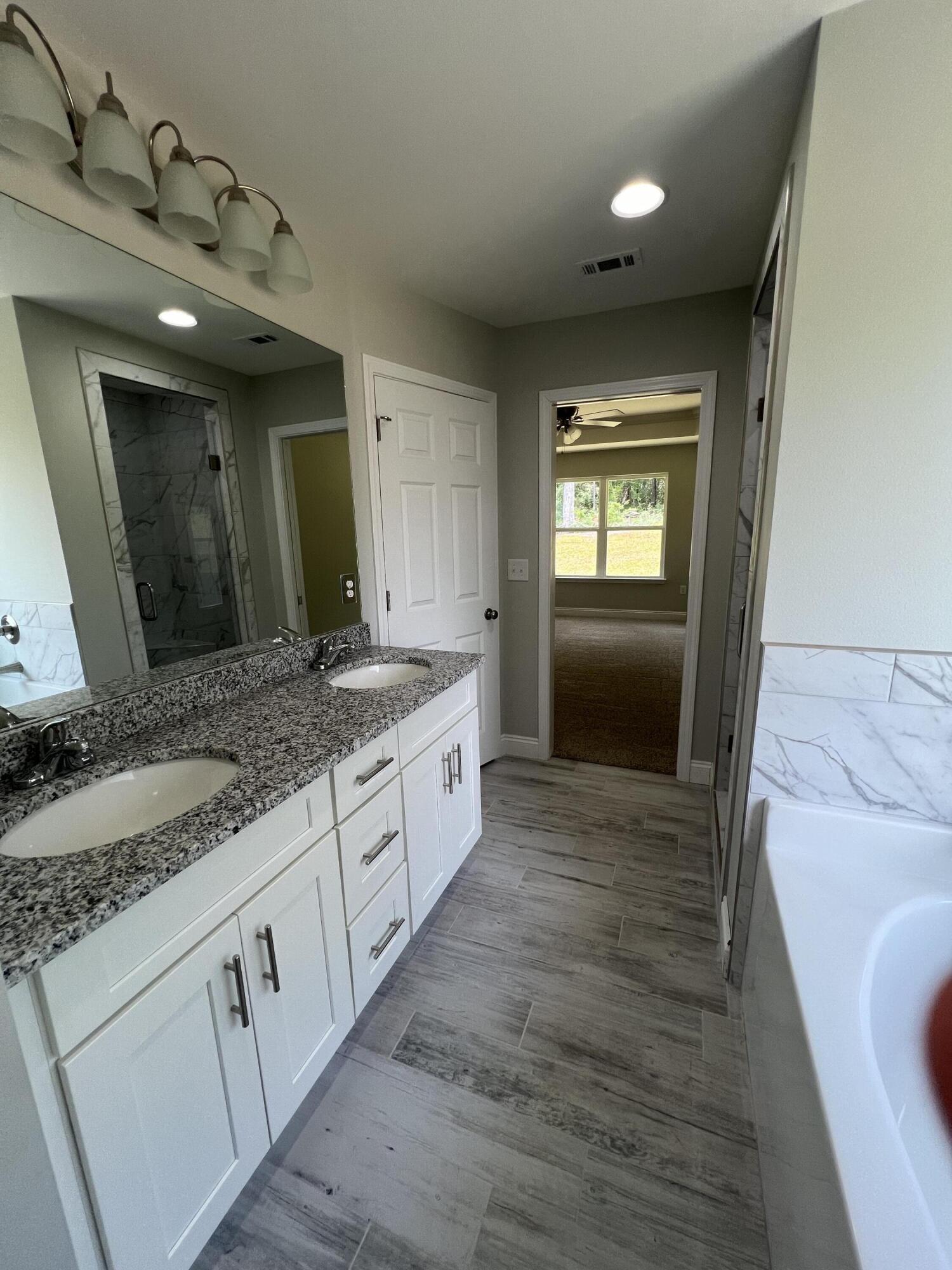 3931 Poverty Creek Road Crestview, FL 32539 - Photo 34 of 34 a bathroom with a sink a vanity and a large mirror
