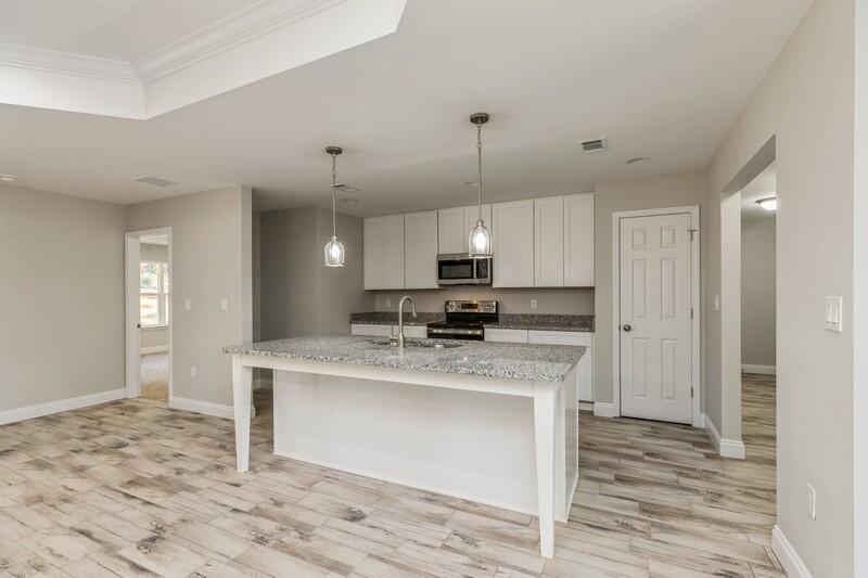 3931 Poverty Creek Road Crestview, FL 32539 - Photo 6 of 34 a large kitchen with kitchen island a sink stainless steel appliances and cabinets