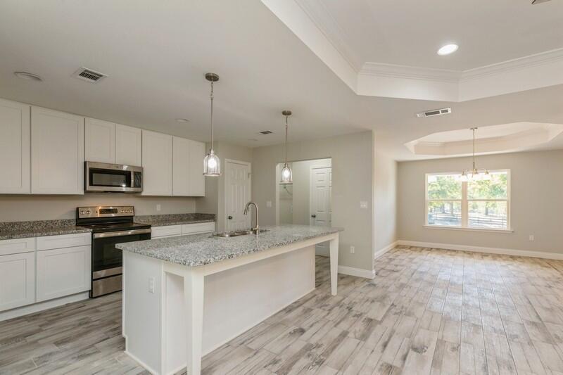 3931 Poverty Creek Road Crestview, FL 32539 - Photo 9 of 34 a kitchen with stainless steel appliances granite countertop a sink stove and refrigerator