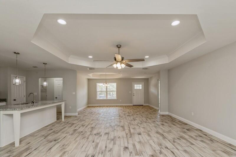 3931 Poverty Creek Road Crestview, FL 32539 - Photo 10 of 34 a view of an empty room and kitchen with a ceiling fan window