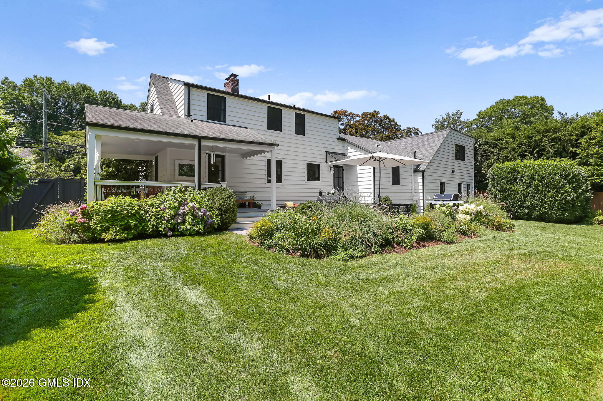 39 Indian Field Road Greenwich, CT 06830 - Photo 2 of 8 a front view of a house with a yard