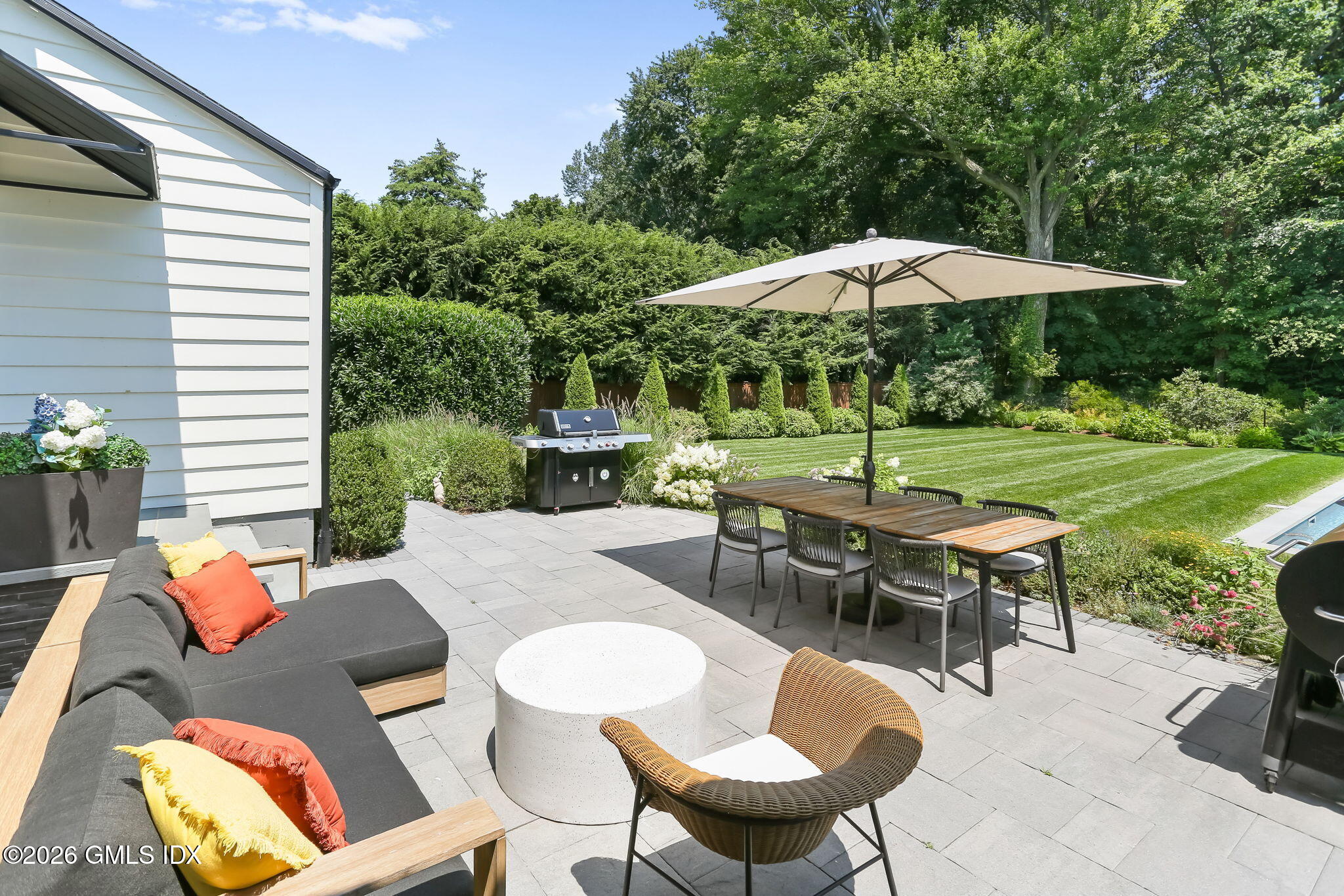 39 Indian Field Road Greenwich, CT 06830 - Photo 7 of 8 a backyard view with a seating space