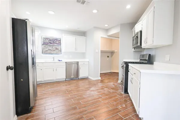 a kitchen with a sink stove and cabinets