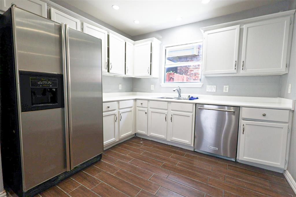 815 Valleycreek Road Mesquite, TX 75181 - Photo 12 of 31 a kitchen with white cabinets white stainless steel appliances and sink