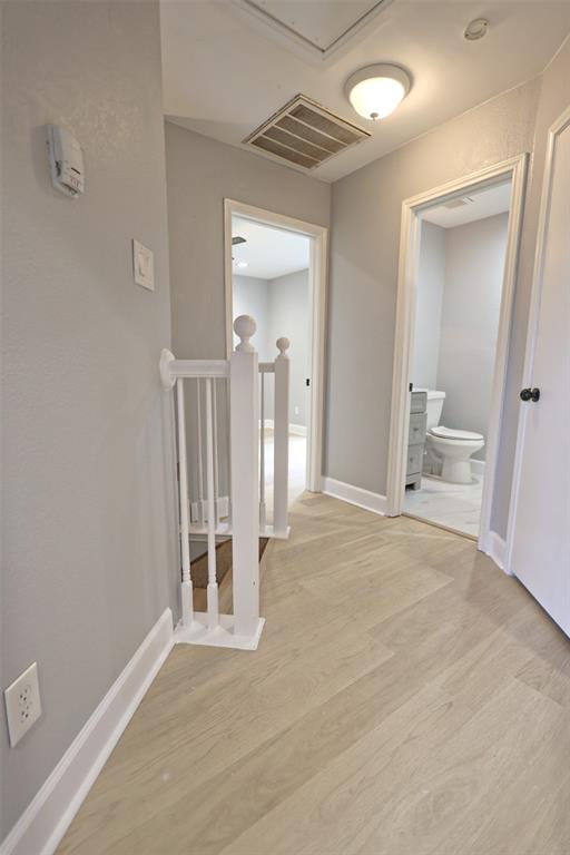 815 Valleycreek Road Mesquite, TX 75181 - Photo 14 of 31 a view of an empty room with wooden floor and a bathroom