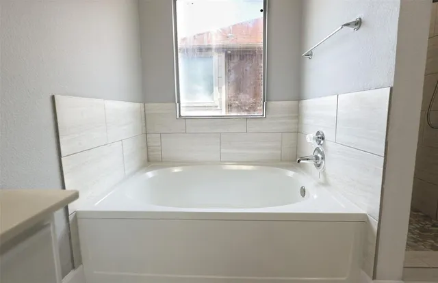 a bathroom with a bathtub and a shower