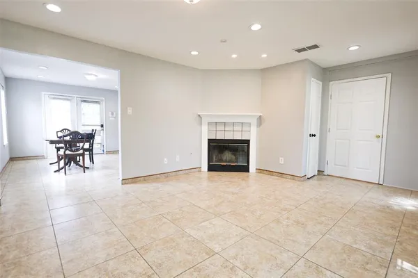 a view of livingroom with dining area a fireplace and a window