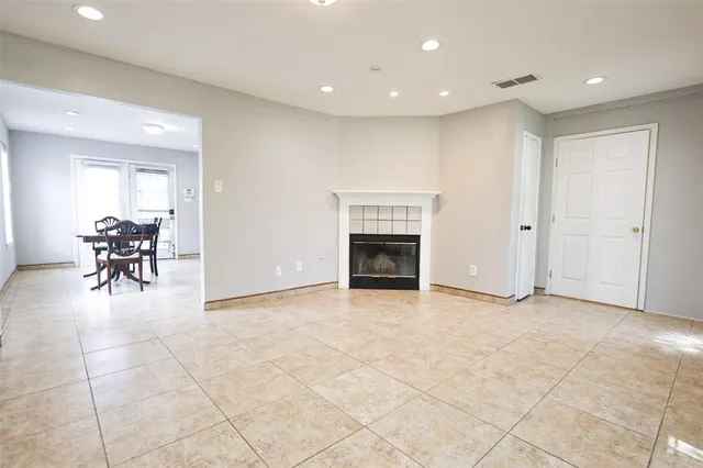 a view of livingroom with dining area a fireplace and a window