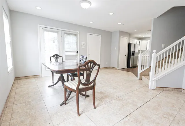 a dining room with furniture and a chandelier
