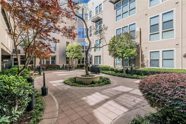 a view of a building with garden and trees