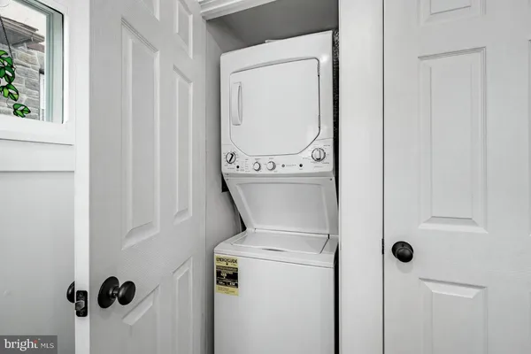 a close view of a utility room with dryer and washer