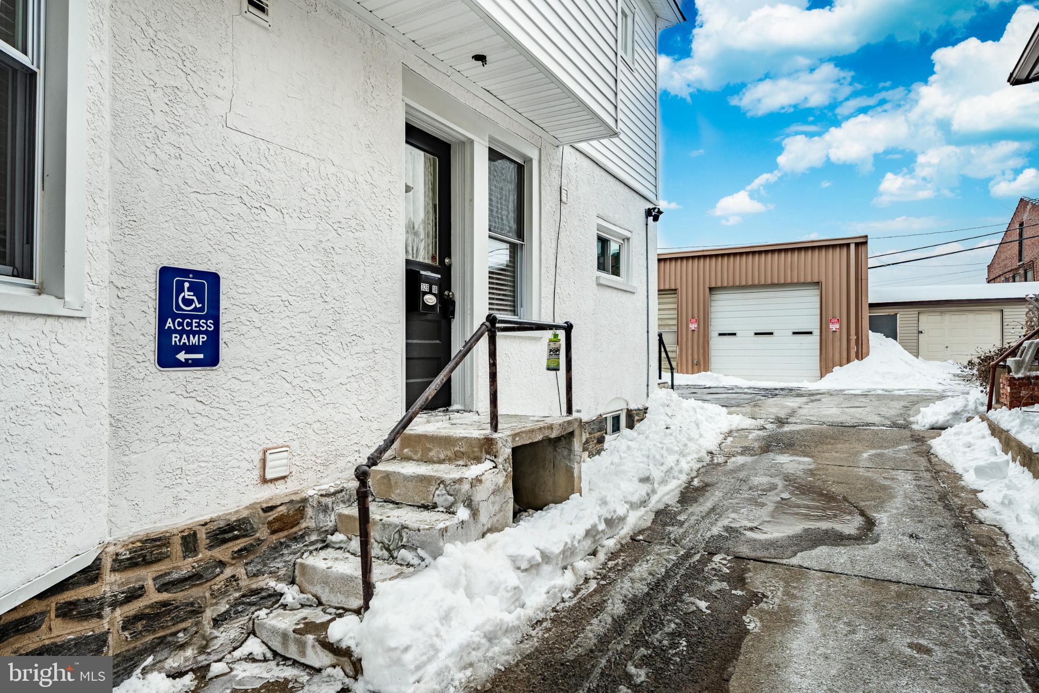 324-326 Darby Road, Unit 1R Havertown, PA 19083 - Photo 15 of 17 Accessible entryway amidst winter's embrace.