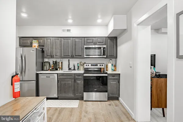 a kitchen with stainless steel appliances granite countertop a refrigerator and a sink