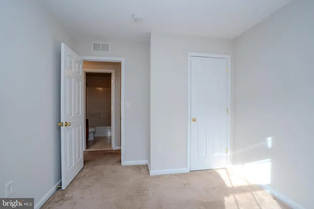 a view of an empty room and a window