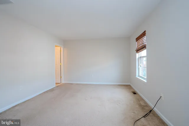 an empty room with windows and entrance