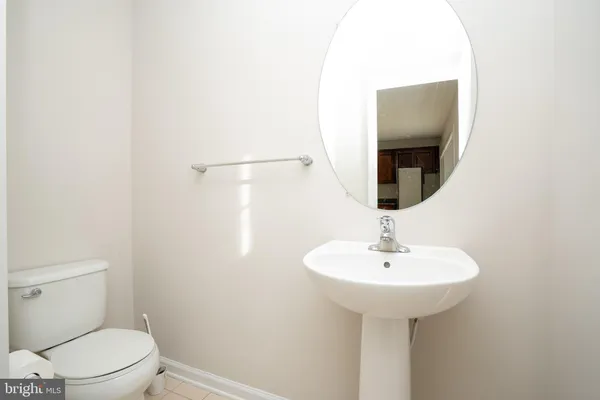 a bathroom with a sink toilet and a mirror