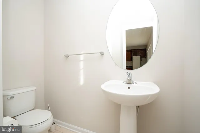 a bathroom with a sink toilet and a mirror