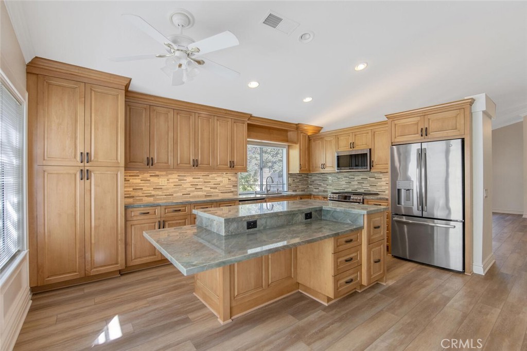 27619-27619 Ron Ridge Drive Saugus, CA 91350 - Photo 11 of 37 a kitchen with a stove a refrigerator and a sink