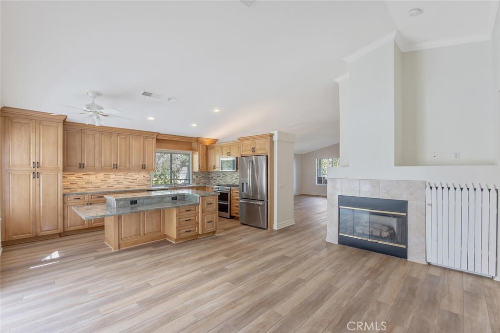 27619-27619 Ron Ridge Drive Saugus, CA 91350 - Photo 14 of 37 a kitchen with stainless steel appliances granite countertop a stove and cabinets