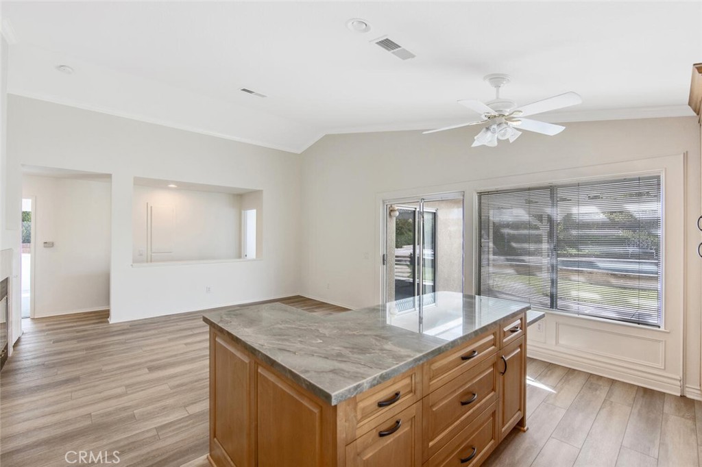 27619-27619 Ron Ridge Drive Saugus, CA 91350 - Photo 15 of 37 a kitchen with kitchen island a counter top space and a ceiling fan