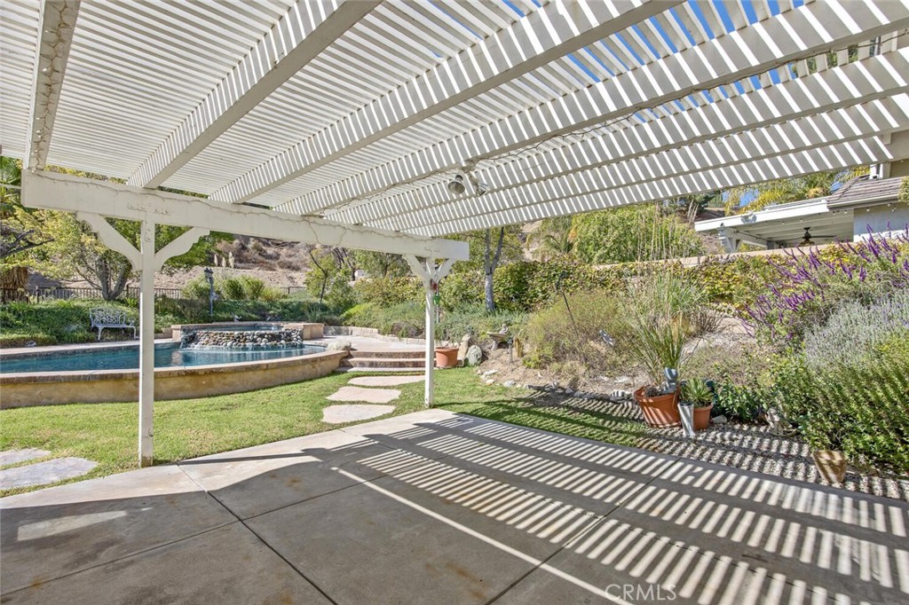 27619-27619 Ron Ridge Drive Saugus, CA 91350 - Photo 23 of 37 a view of a swimming pool with a patio