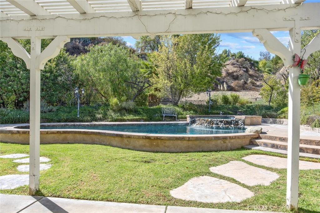 27619-27619 Ron Ridge Drive Saugus, CA 91350 - Photo 24 of 37 a view of a swimming pool with a patio