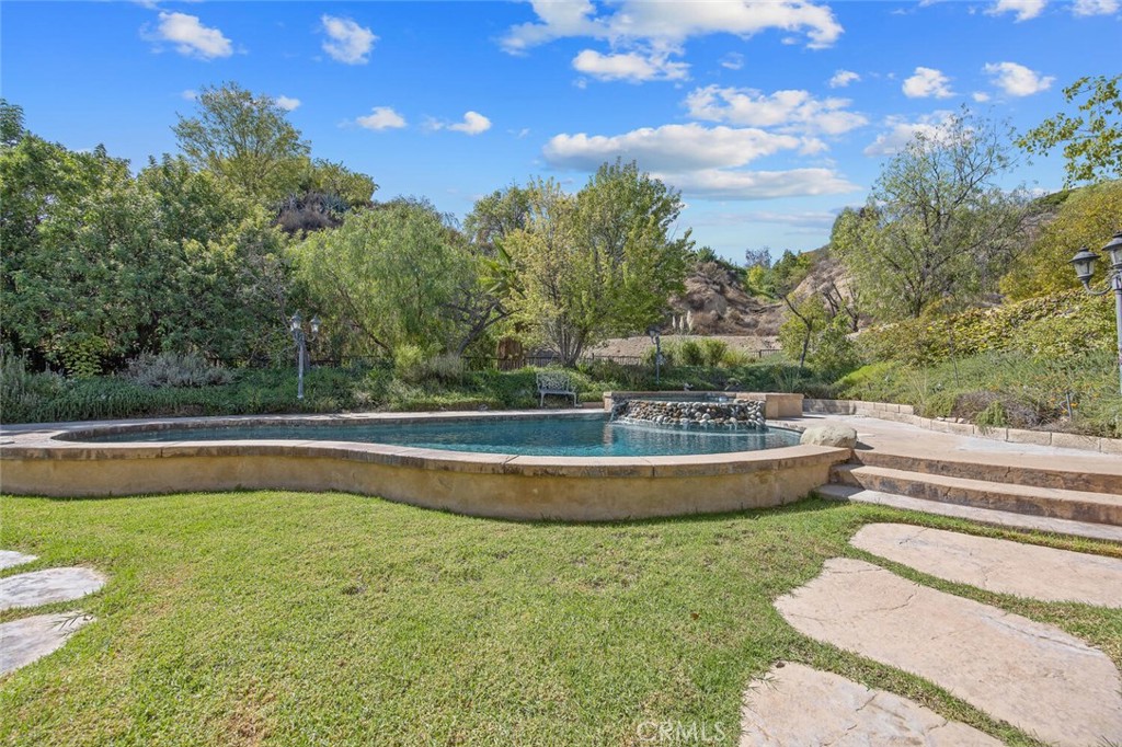 27619-27619 Ron Ridge Drive Saugus, CA 91350 - Photo 25 of 37 a view of a swimming pool with a yard