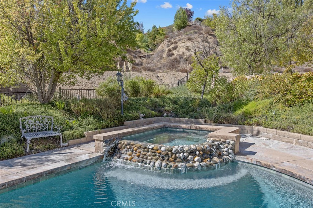 27619-27619 Ron Ridge Drive Saugus, CA 91350 - Photo 27 of 37 a view of a swimming pool with a garden