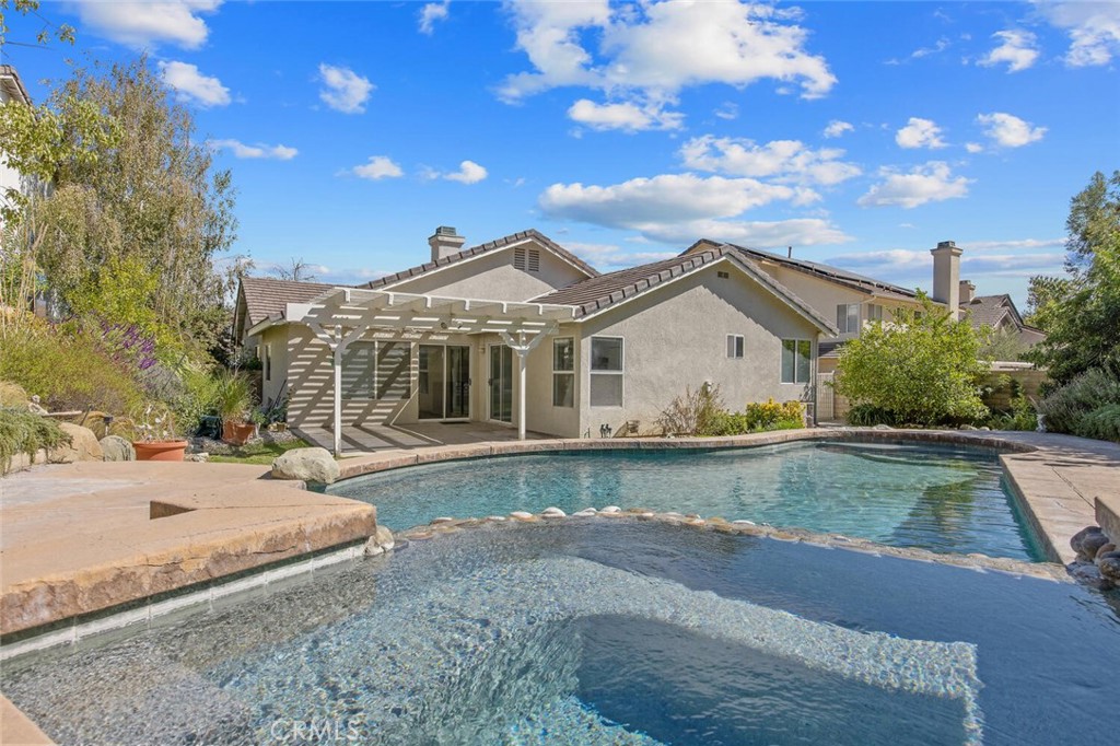 27619-27619 Ron Ridge Drive Saugus, CA 91350 - Photo 31 of 37 a view of a white house with a yard