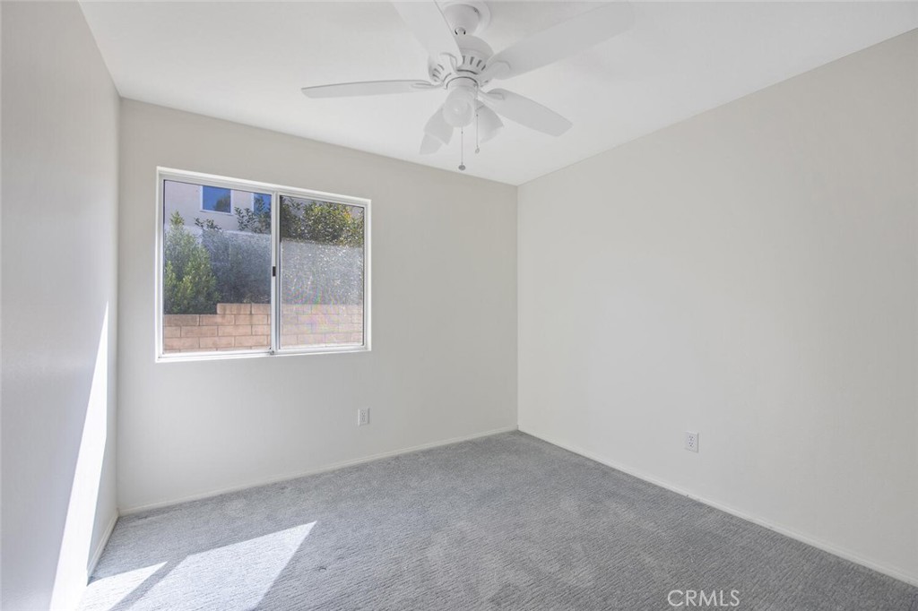 27619-27619 Ron Ridge Drive Saugus, CA 91350 - Photo 37 of 37 an empty room with a window and a fan