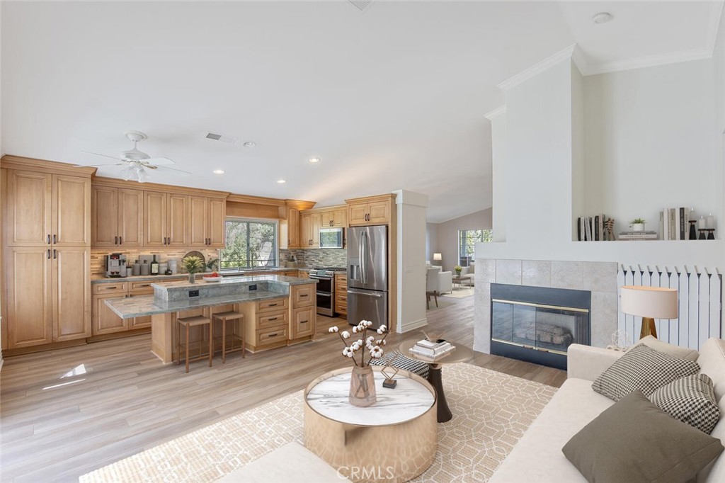 27619-27619 Ron Ridge Drive Saugus, CA 91350 - Photo 5 of 37 a living room with stainless steel appliances furniture a fireplace and a kitchen view