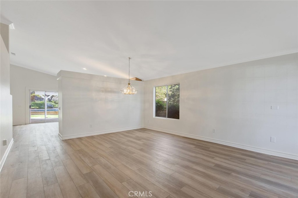 27619-27619 Ron Ridge Drive Saugus, CA 91350 - Photo 6 of 37 an empty room with wooden floor and windows