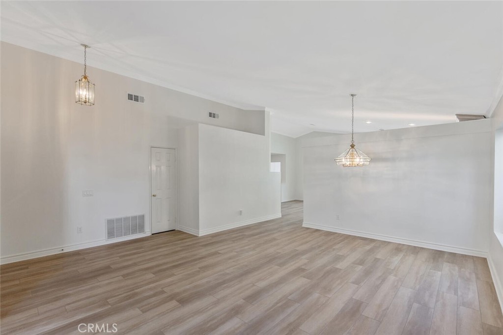 27619-27619 Ron Ridge Drive Saugus, CA 91350 - Photo 7 of 37 an empty room with wooden floor and windows