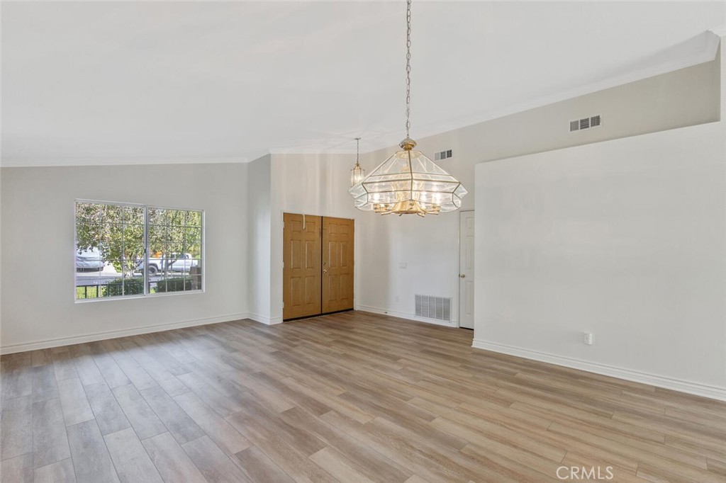 27619-27619 Ron Ridge Drive Saugus, CA 91350 - Photo 8 of 37 a view of a livingroom with a chandelier wooden floor and chandelier