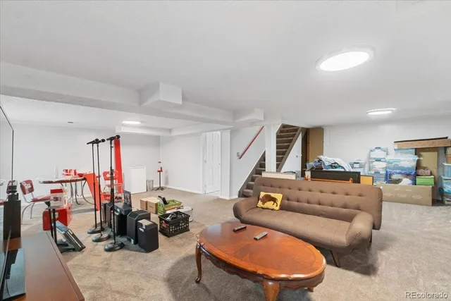 a living room with furniture a air conditioner and a window