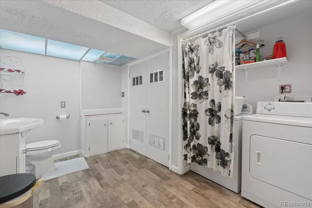 a bathroom with a sink a toilet and shower curtain
