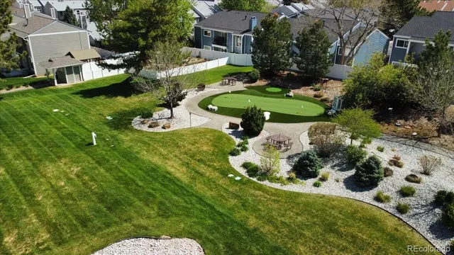 an aerial view of a house with yard swimming pool and outdoor seating
