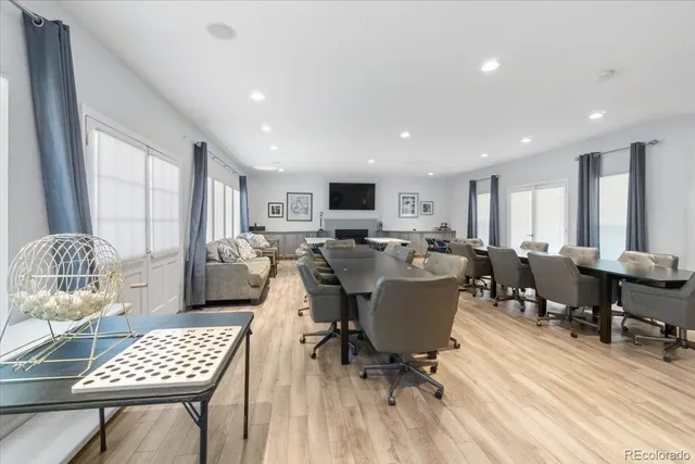 a living room with furniture a dining table and a window