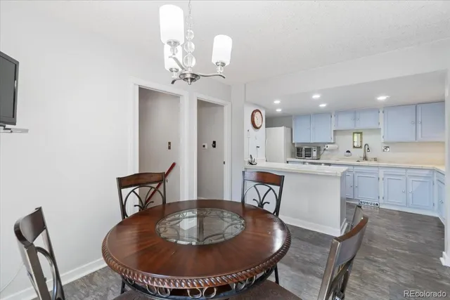 a kitchen with a dining table and chairs
