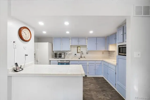 a kitchen with cabinets a sink and stainless steel appliances