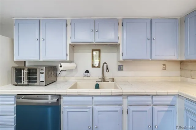 a kitchen with stainless steel appliances granite countertop a sink a stove and cabinets