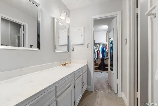 a bathroom with a sink a vanity and a mirror